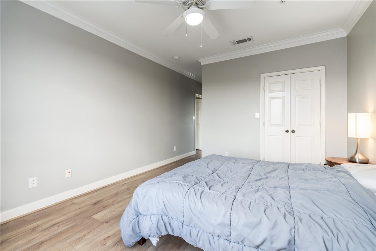 7701 Rialto Boulevard, Unit 91 Austin, TX 78735 - Photo 21 of 39 a bedroom with a bed and a ceiling fan