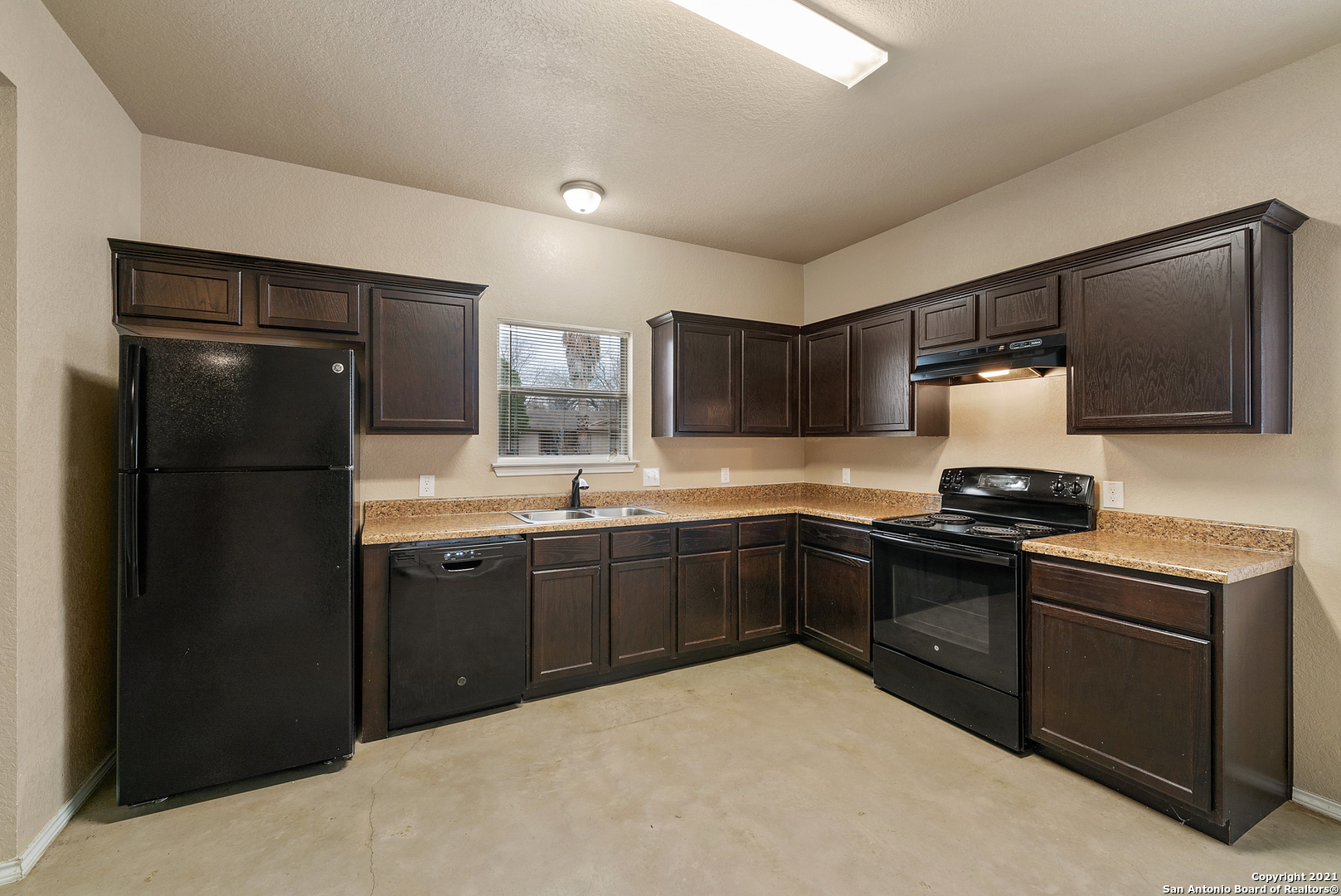 1534 Lahn Road New Braunfels, TX 78130 - Photo 12 of 25 a kitchen with stainless steel appliances granite countertop a refrigerator stove and sink