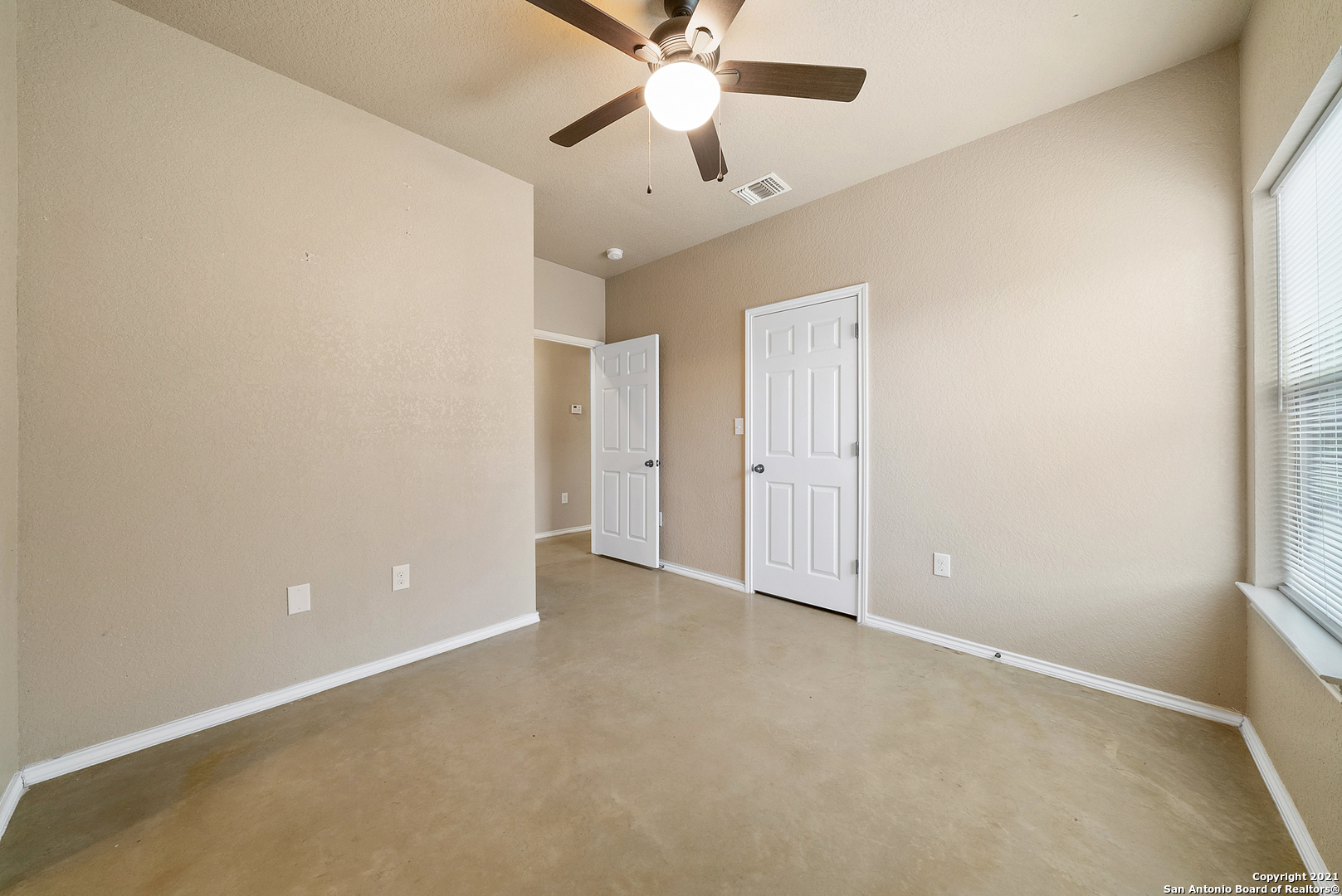 1534 Lahn Road New Braunfels, TX 78130 - Photo 15 of 25 an empty room with chandelier fan and windows