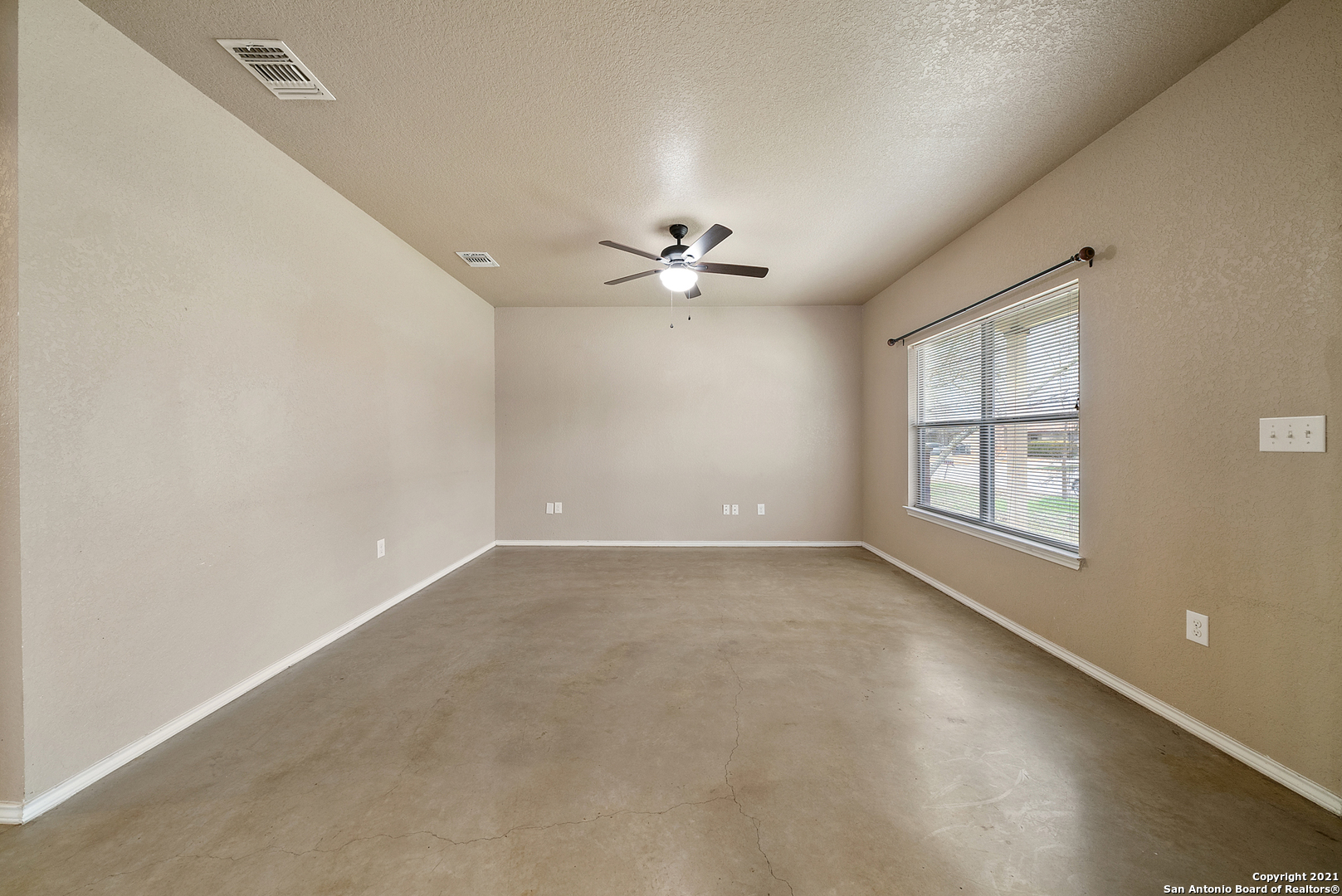 1534 Lahn Road New Braunfels, TX 78130 - Photo 6 of 25 an empty room with a window and a ceiling fan
