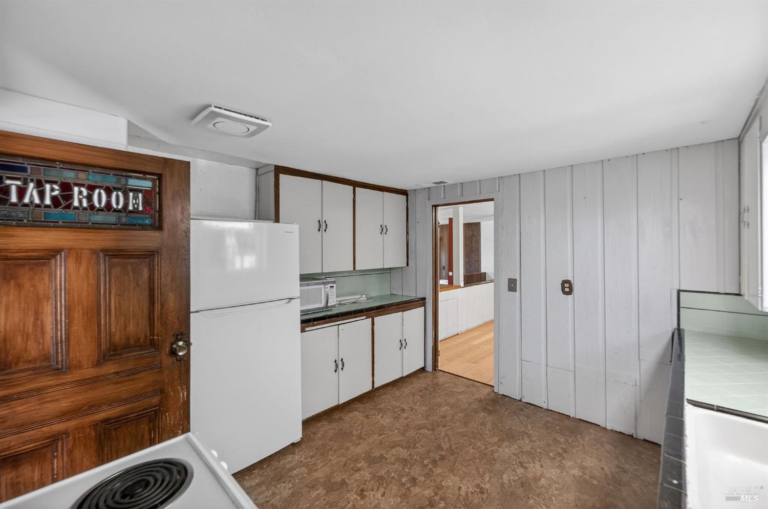 1450 Timberhill Road Santa Rosa, CA 95401 - Photo 21 of 50 a kitchen with white cabinets and refrigerator
