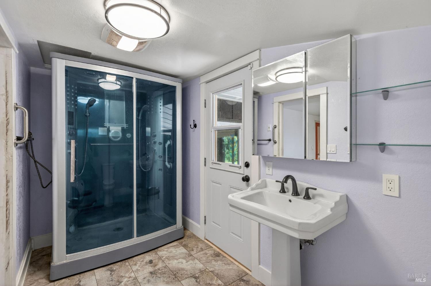 1450 Timberhill Road Santa Rosa, CA 95401 - Photo 28 of 50 a bathroom with a sink mirror and shower