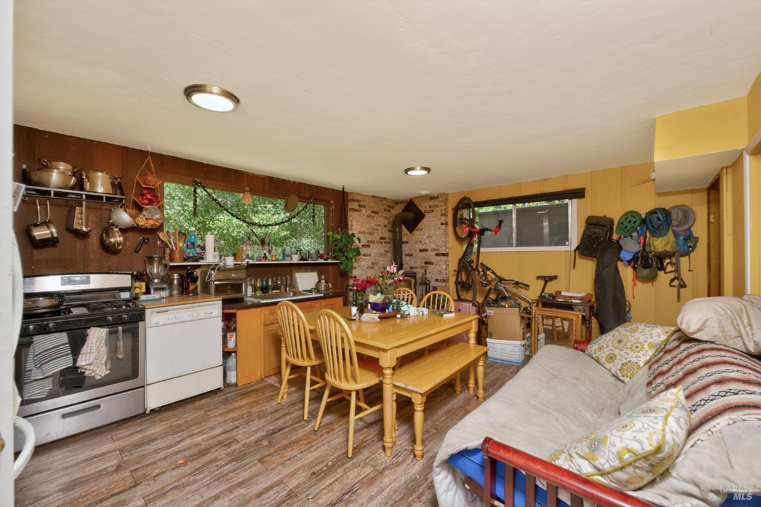 1450 Timberhill Road Santa Rosa, CA 95401 - Photo 34 of 50 a living room with furniture a flat screen tv and a floor to ceiling window