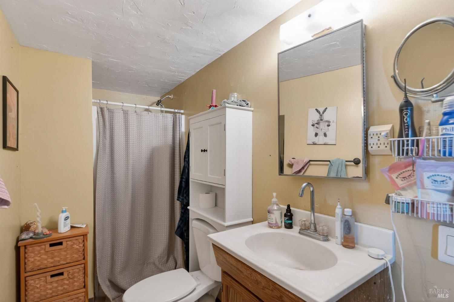1450 Timberhill Road Santa Rosa, CA 95401 - Photo 37 of 50 a bathroom with a sink vanity mirror and toilet