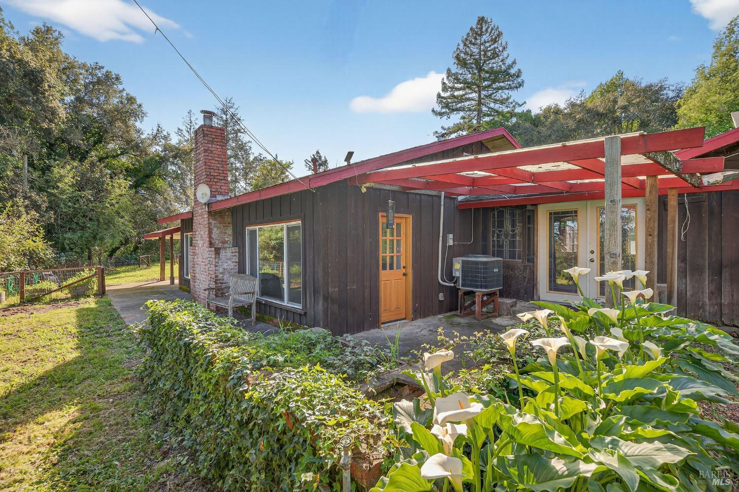 1450 Timberhill Road Santa Rosa, CA 95401 - Photo 45 of 50 a view of a house with floor to ceiling windows and a basket ball poll