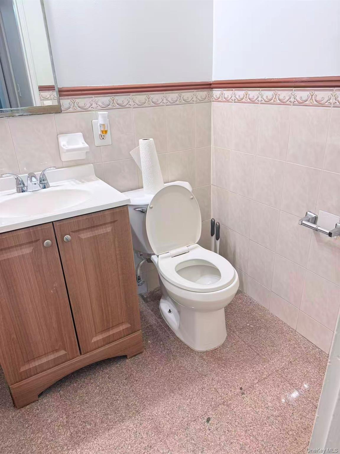 41-07 Bowne Street, Unit 1 Queens, NY 11355 - Photo 9 of 10 a white toilet sitting next to a bathroom sink