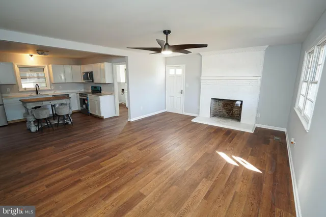 a view of kitchen and hall with wooden floor
