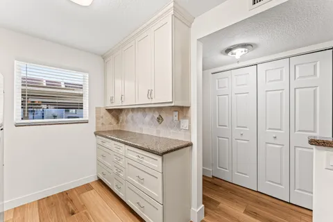 a kitchen with a refrigerator stove and cabinets