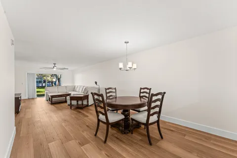 a kitchen with stainless steel appliances a sink and wooden floor