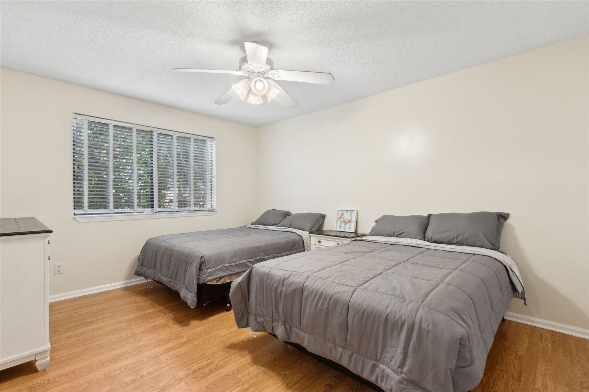 2583 Forest Ridge Drive, Unit N3 Fernandina Beach, FL 32034 - Photo 19 of 34 a bedroom with two beds and a chandelier