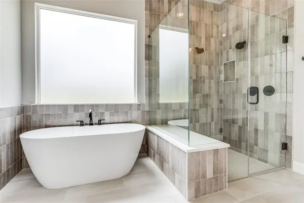 a bathroom with a bathtub and shower