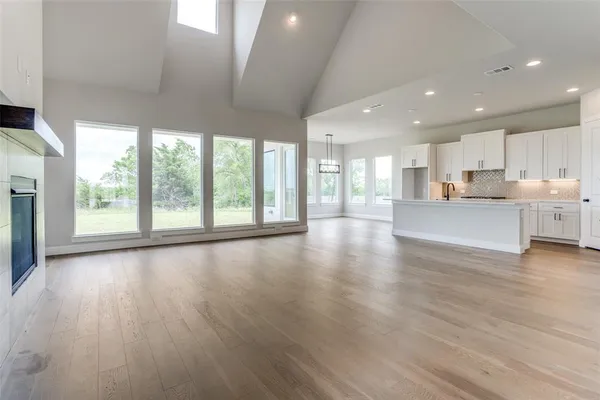 a view of kitchen with wooden floor and windows