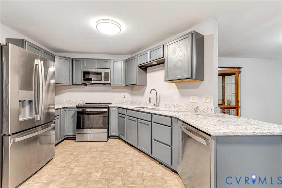 8703 Ewes Court Chesterfield, VA 23236 - Photo 12 of 31 a kitchen with granite countertop a sink stove and refrigerator