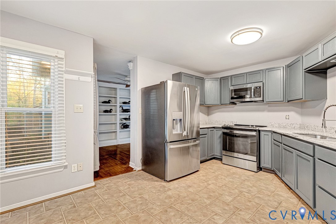 8703 Ewes Court Chesterfield, VA 23236 - Photo 13 of 31 a kitchen with granite countertop a refrigerator and a stove top oven