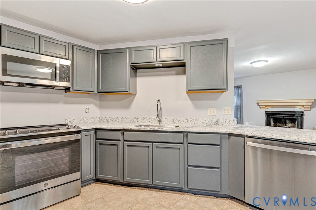 8703 Ewes Court Chesterfield, VA 23236 - Photo 16 of 31 a kitchen with granite countertop a sink stainless steel appliances and cabinets