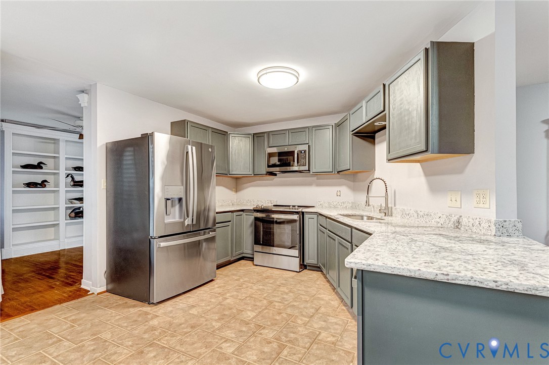 8703 Ewes Court Chesterfield, VA 23236 - Photo 18 of 31 a kitchen with granite countertop a refrigerator stove and sink