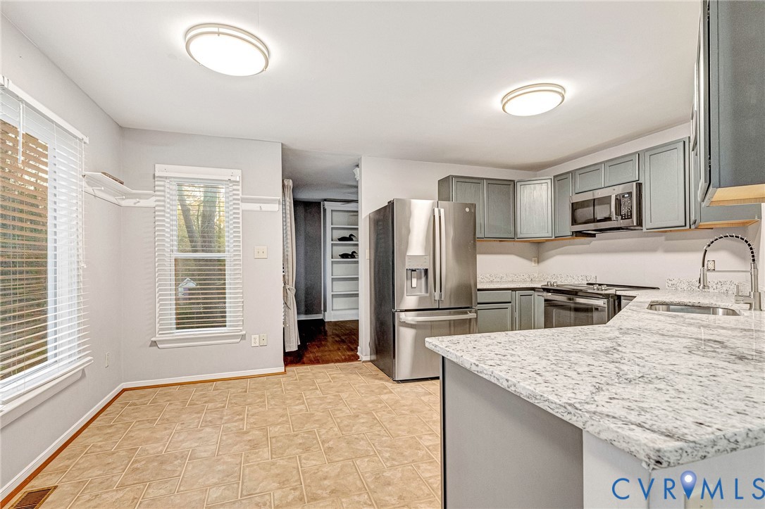 8703 Ewes Court Chesterfield, VA 23236 - Photo 19 of 31 a kitchen with stainless steel appliances granite countertop a sink stove and refrigerator