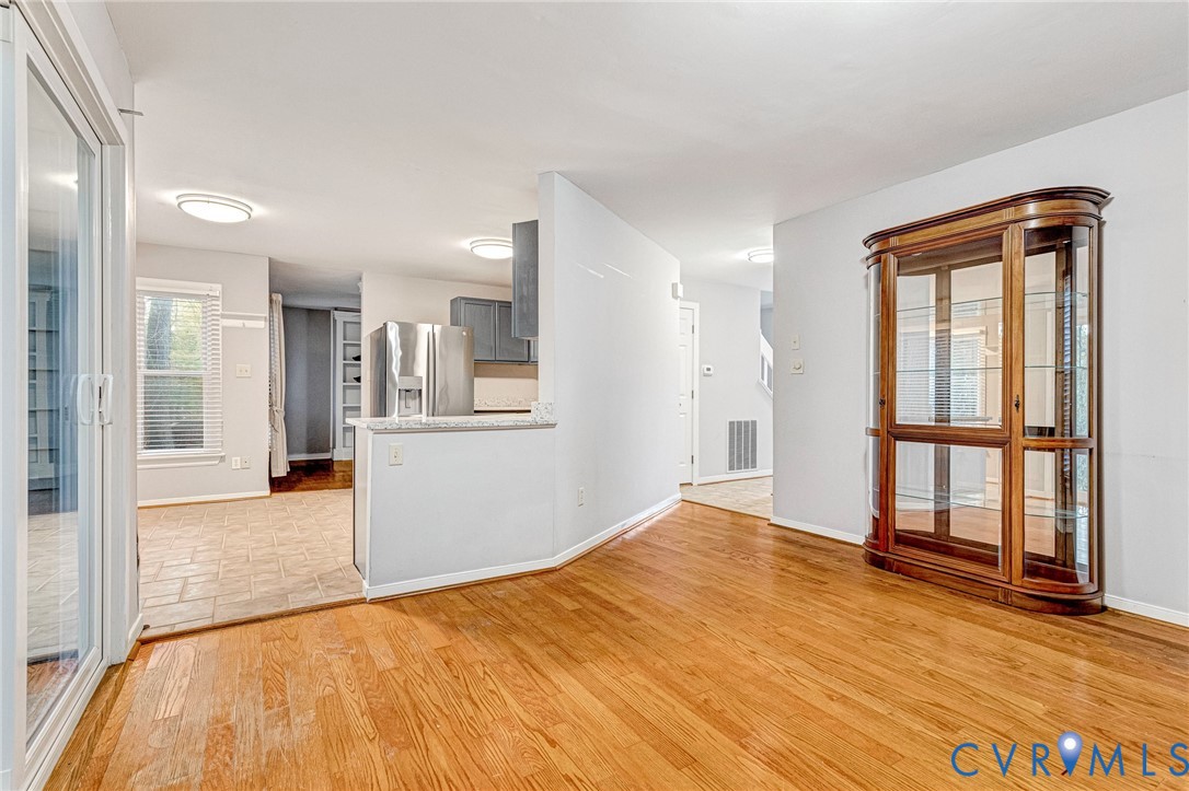 8703 Ewes Court Chesterfield, VA 23236 - Photo 24 of 31 a view of empty room with wooden floor and windows
