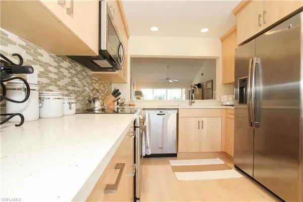 a kitchen with a sink a refrigerator and washer