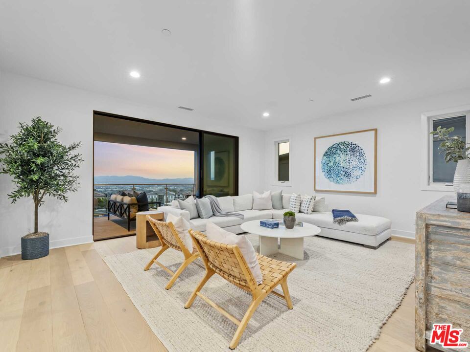 20416 Albion Way Porter Ranch, CA 91326 - Photo 25 of 38 a living room with furniture potted plant and a large window
