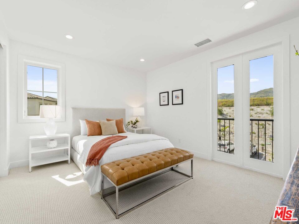 20416 Albion Way Porter Ranch, CA 91326 - Photo 28 of 38 a bedroom with a bed lamp and a window