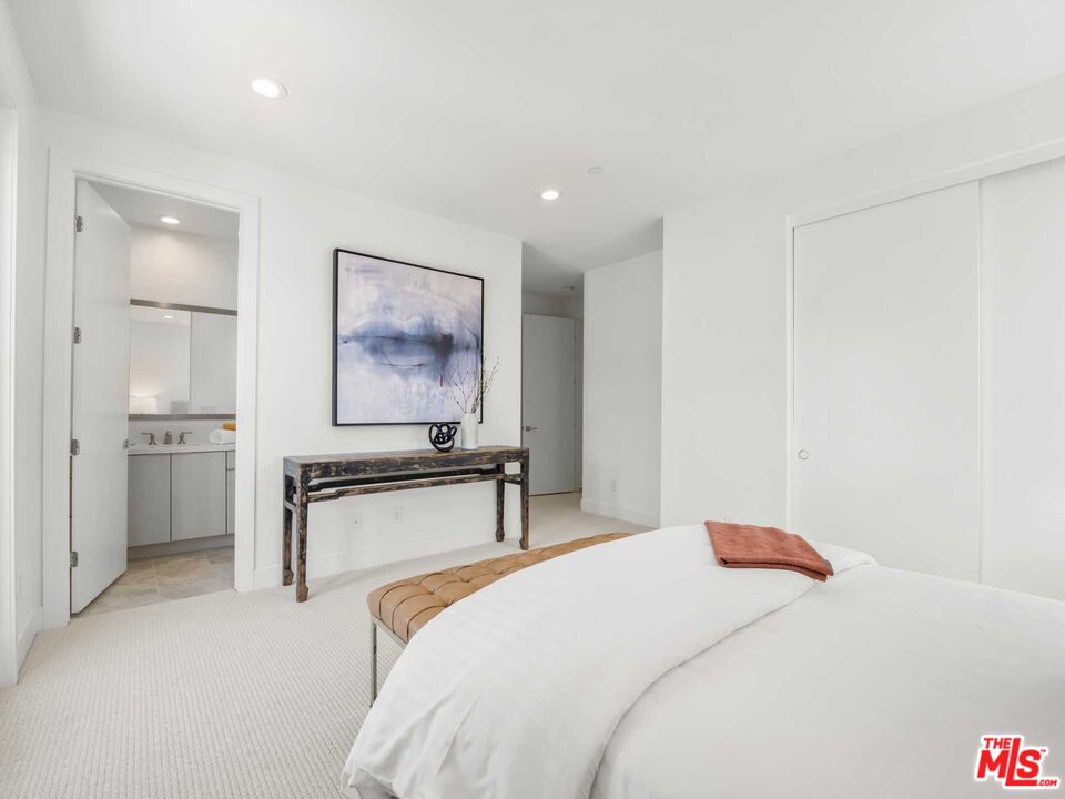 20416 Albion Way Porter Ranch, CA 91326 - Photo 29 of 38 a bedroom with a bed and a chandelier