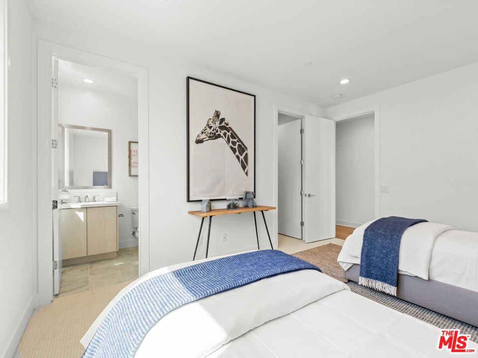 20416 Albion Way Porter Ranch, CA 91326 - Photo 31 of 38 a bedroom with a bed and a chandelier