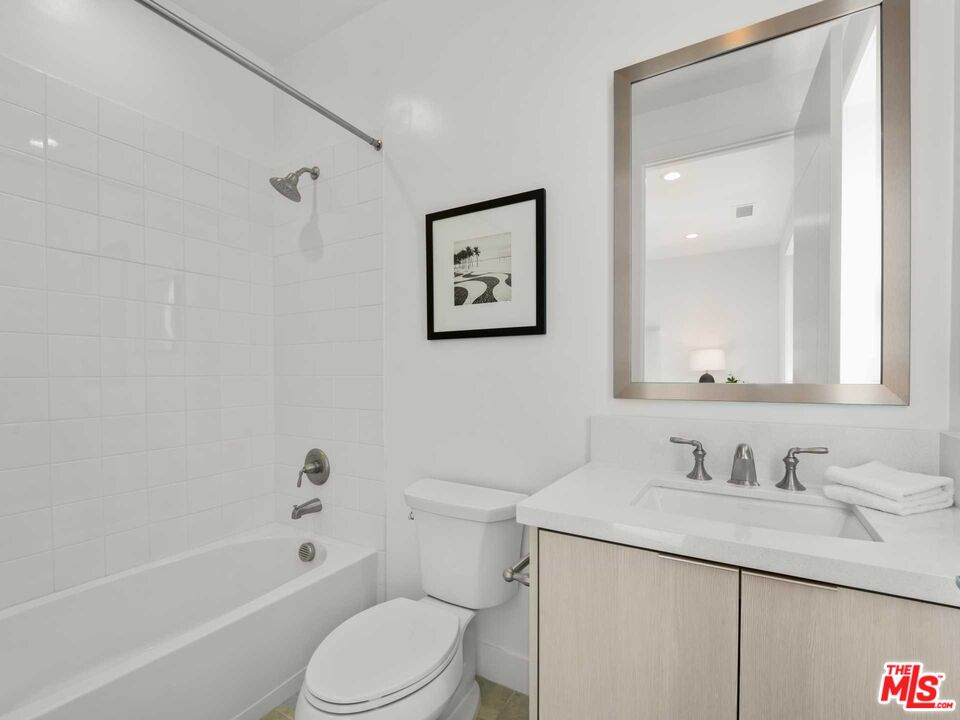 20416 Albion Way Porter Ranch, CA 91326 - Photo 34 of 38 a bathroom with a granite countertop sink toilet and shower