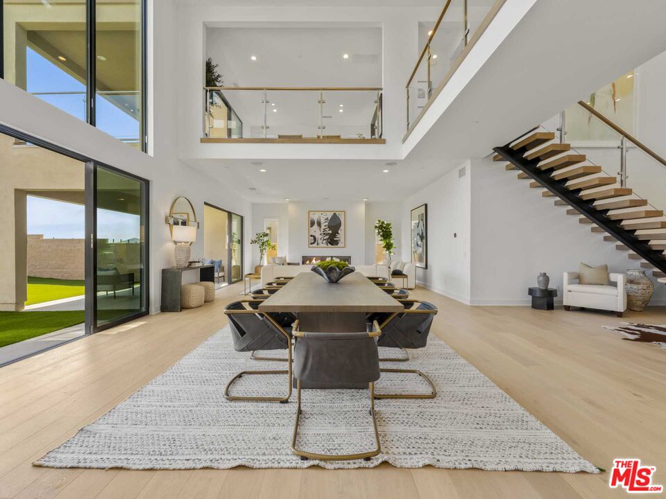 20416 Albion Way Porter Ranch, CA 91326 - Photo 6 of 38 a living room with a rug floor and a floor to ceiling window