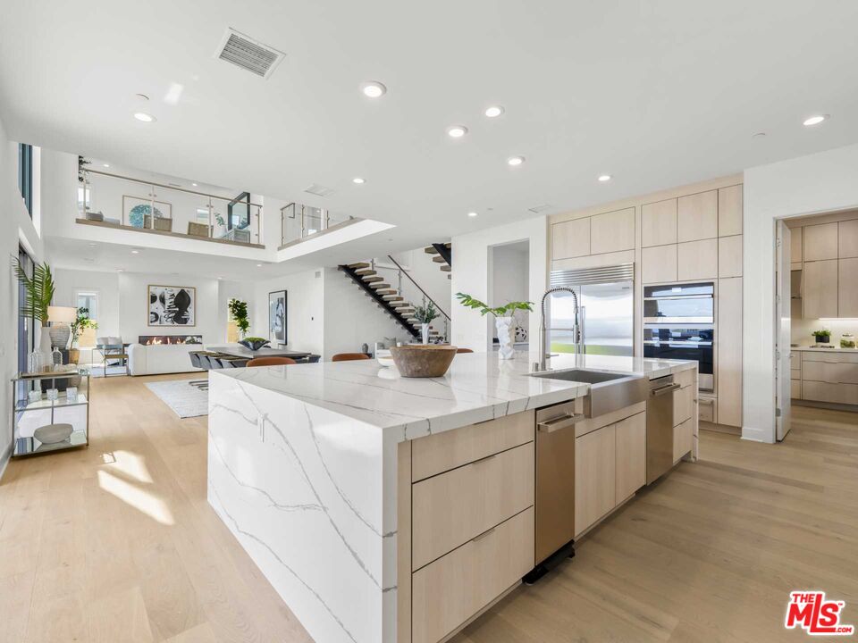 20416 Albion Way Porter Ranch, CA 91326 - Photo 8 of 38 a kitchen with stainless steel appliances granite countertop a sink and white cabinets