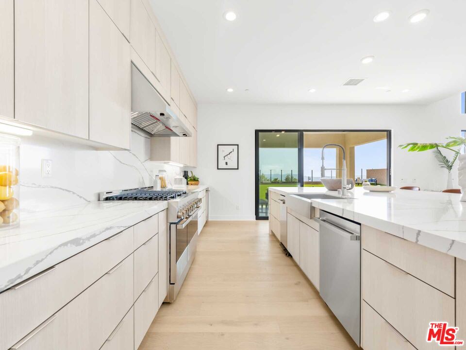 20416 Albion Way Porter Ranch, CA 91326 - Photo 9 of 38 a large kitchen with stainless steel appliances a sink and cabinets