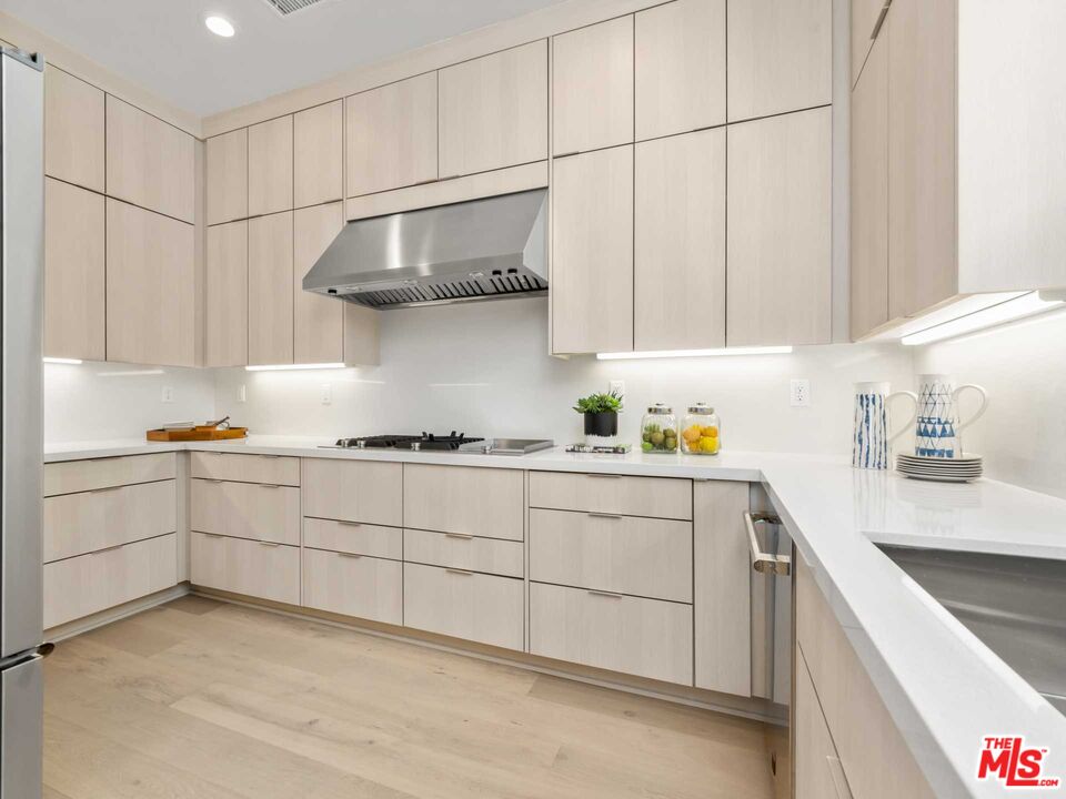 20416 Albion Way Porter Ranch, CA 91326 - Photo 10 of 38 a kitchen with stainless steel appliances granite countertop a sink and cabinets