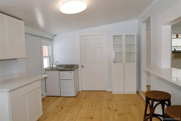 a room with a bed and cabinets