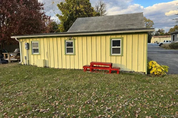 a view of a house with a backyard and porch