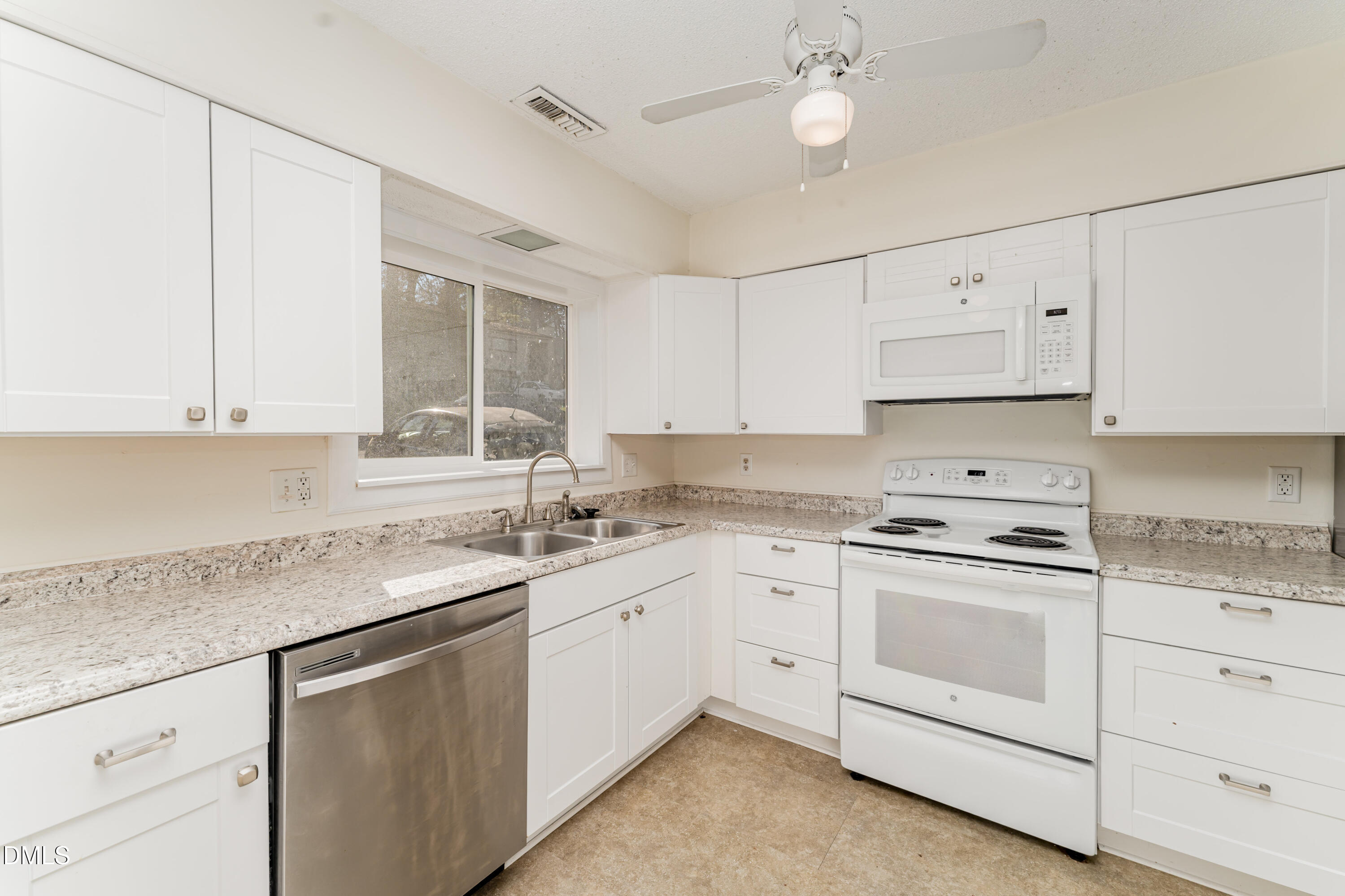 5073 Tall Pines Court Raleigh, NC 27609 - Photo 11 of 32 a kitchen with white cabinets appliances and a sink