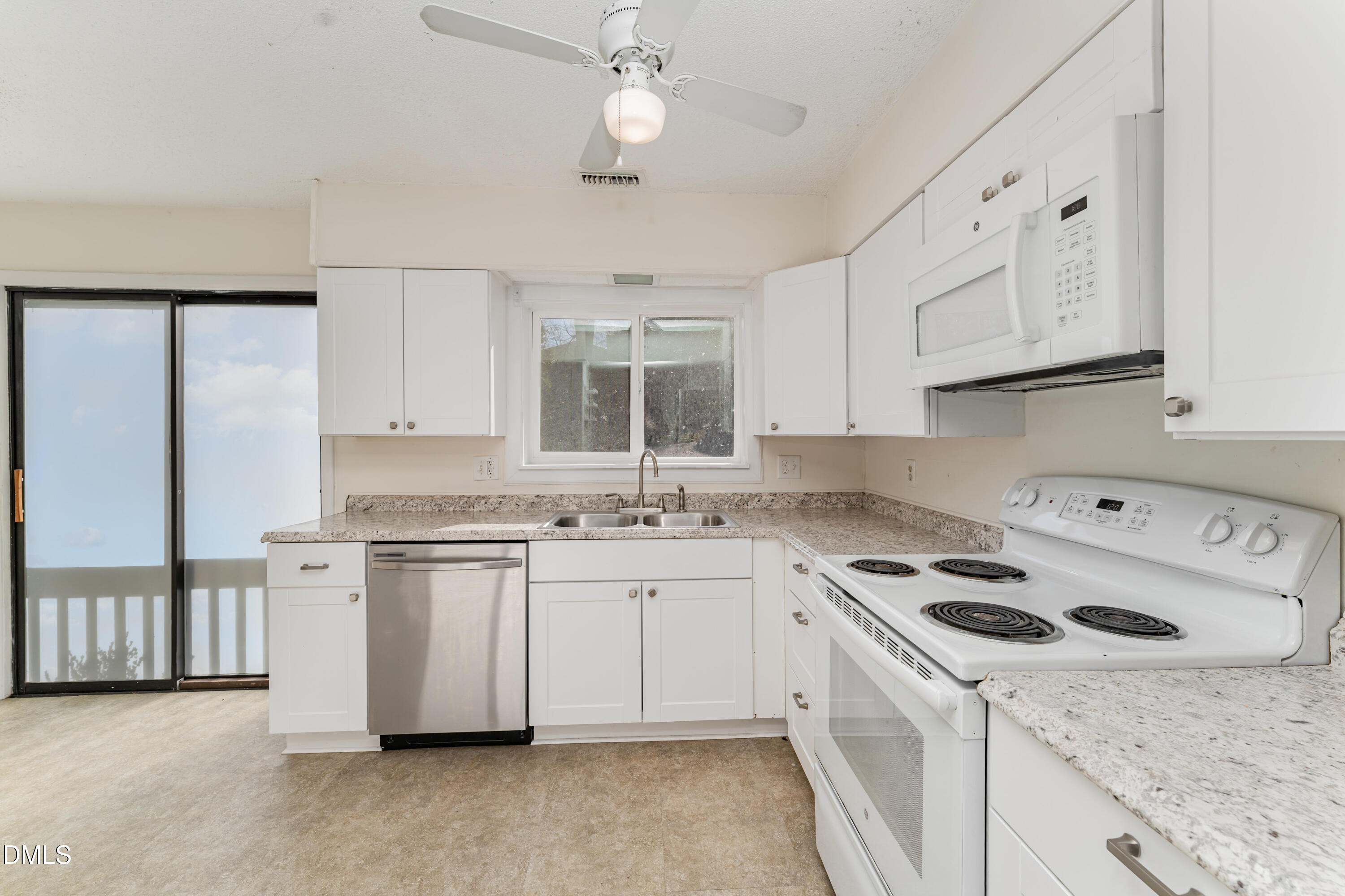5073 Tall Pines Court Raleigh, NC 27609 - Photo 12 of 32 a kitchen with granite countertop a sink a stove and cabinets