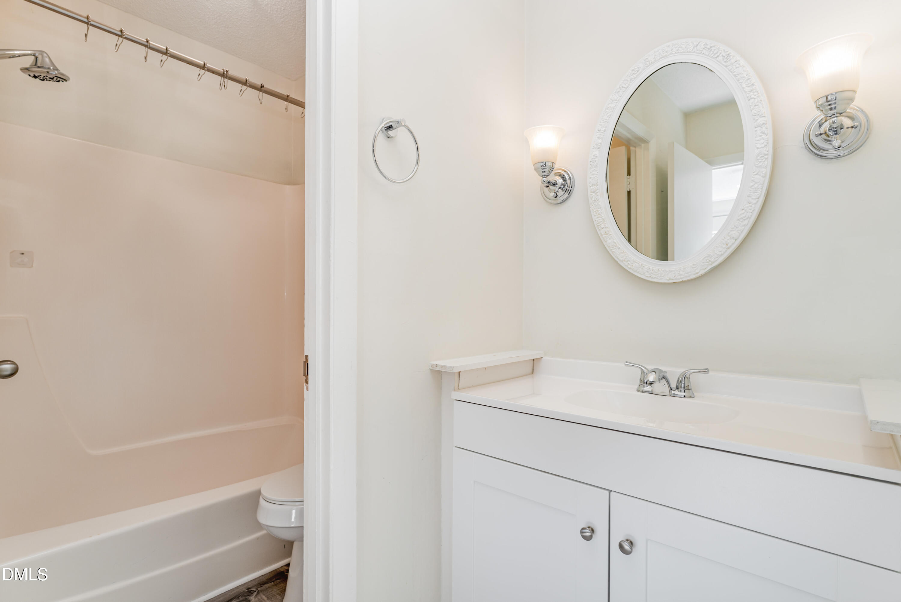 5073 Tall Pines Court Raleigh, NC 27609 - Photo 19 of 32 a bathroom with a sink a vanity and a mirror