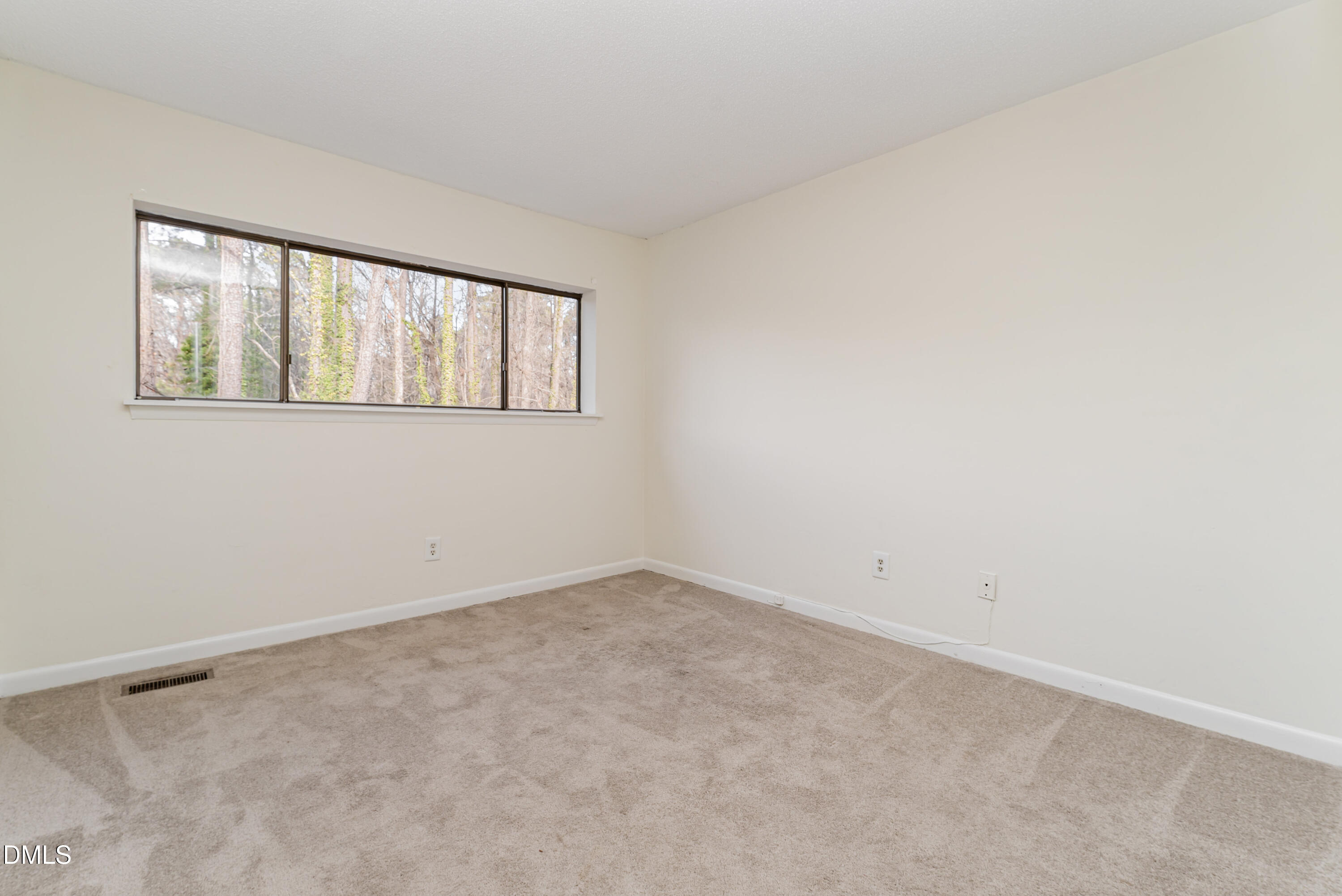 5073 Tall Pines Court Raleigh, NC 27609 - Photo 24 of 32 an empty room with windows