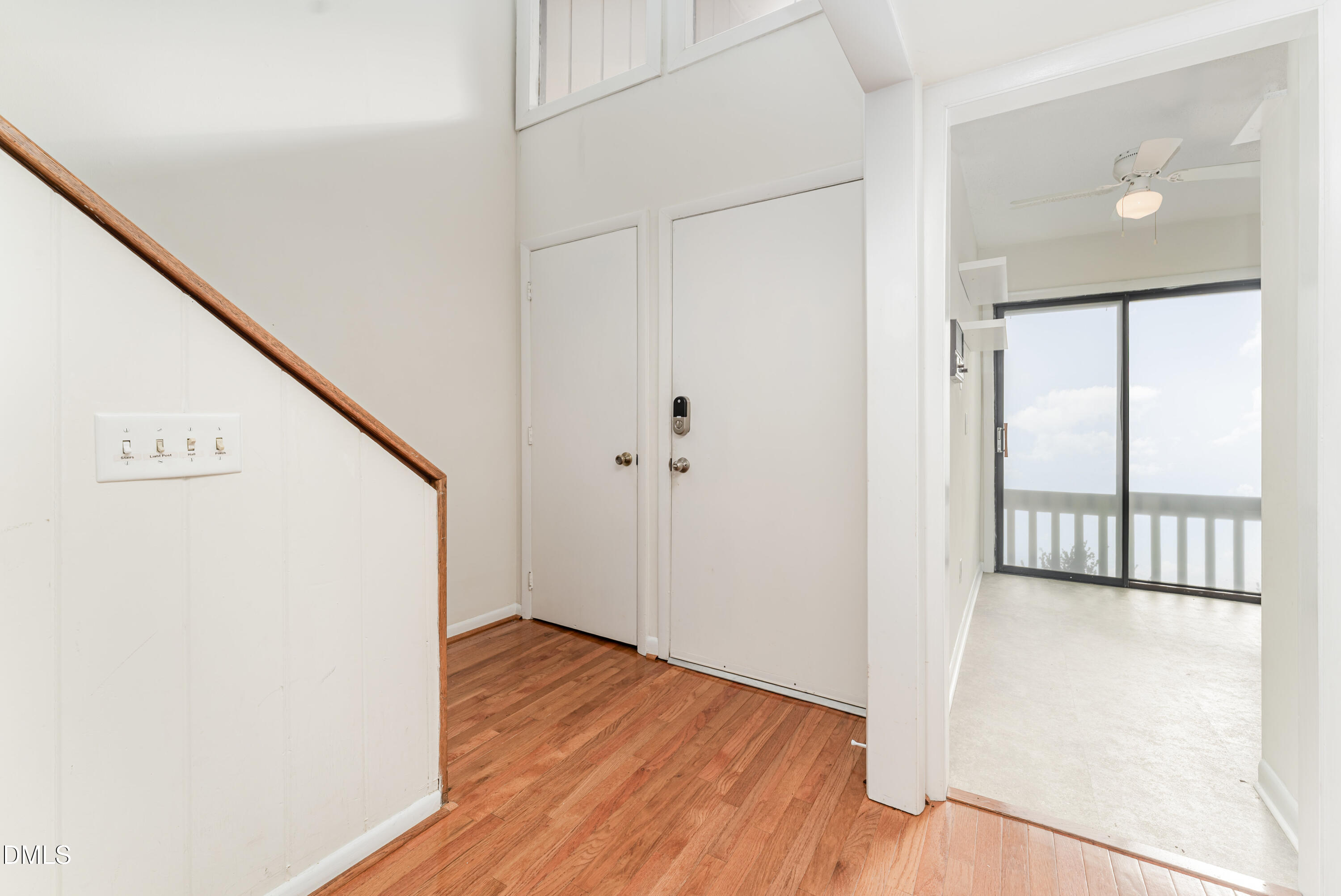 5073 Tall Pines Court Raleigh, NC 27609 - Photo 3 of 32 a view of a hallway with wooden floor and staircase