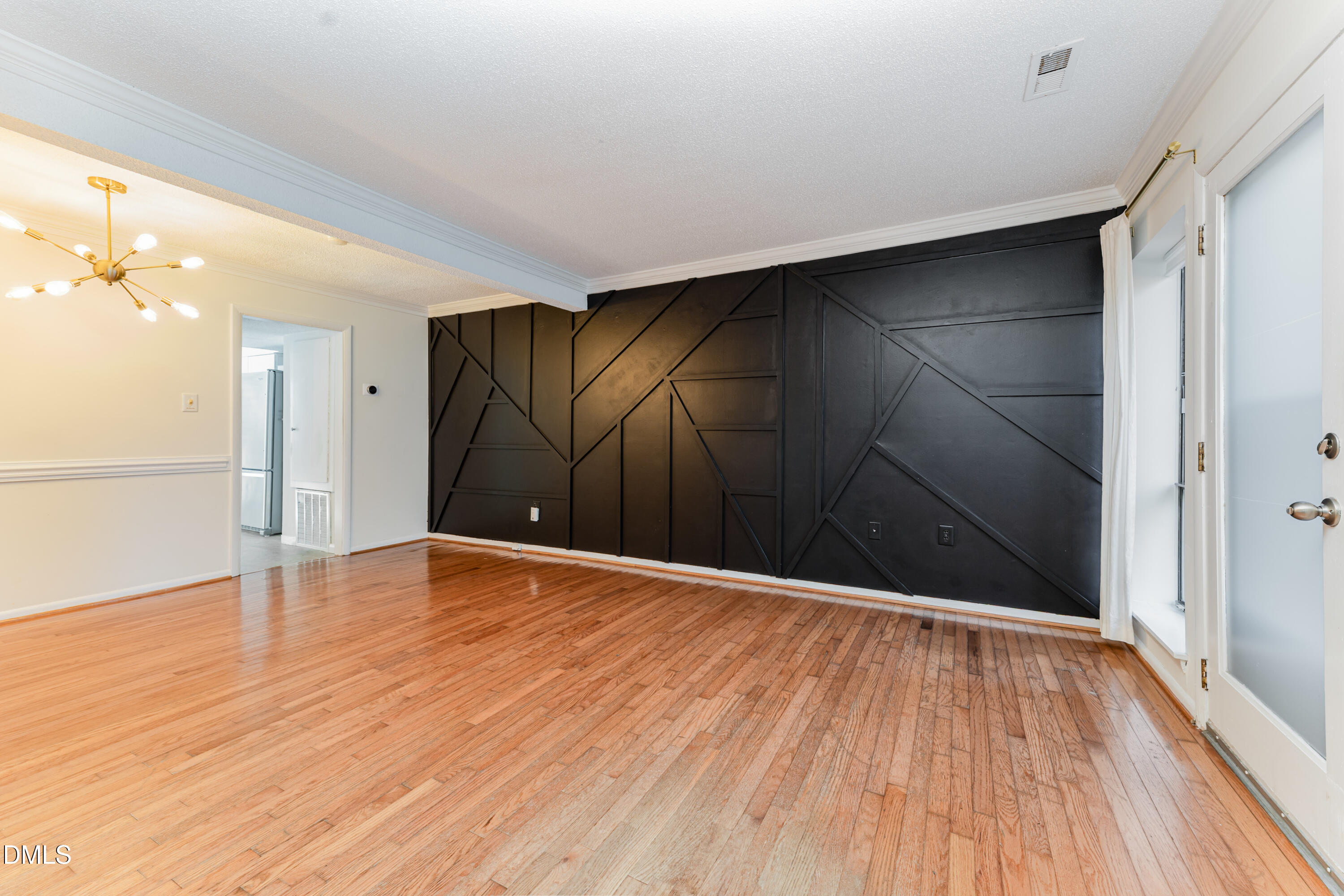 5073 Tall Pines Court Raleigh, NC 27609 - Photo 7 of 32 a view of an empty room with wooden floor