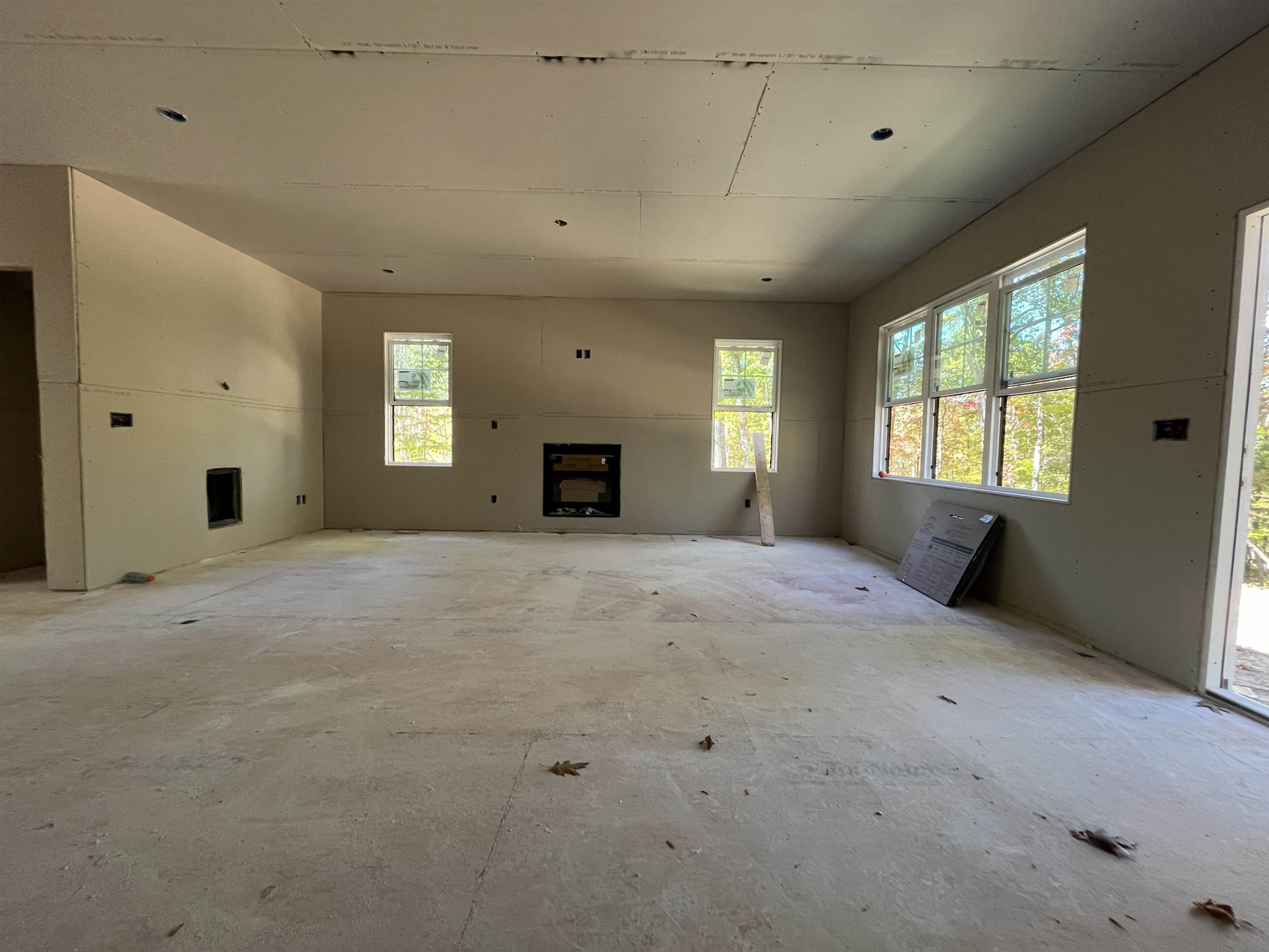 a view of a livingroom with a fireplace and window