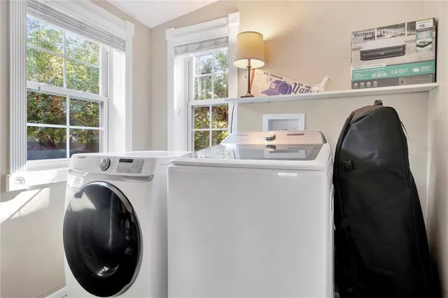 a bathroom with a window and a shower