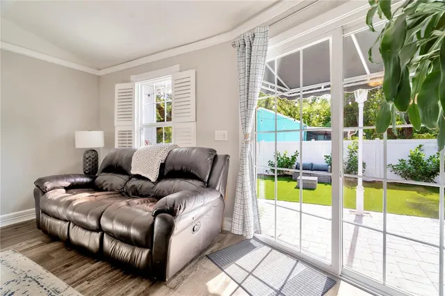 a view of a house with backyard and sitting area