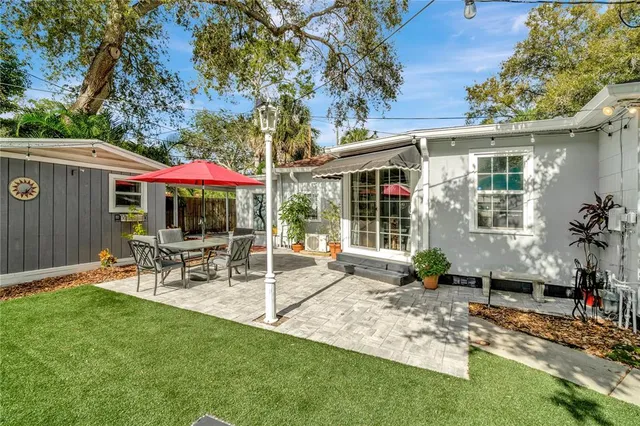 a kitchen with stainless steel appliances cabinets a dining table and chairs