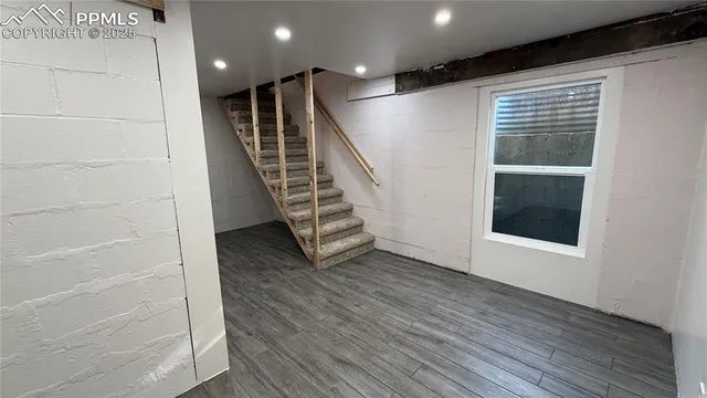 a view of a livingroom with a ceiling fan and window