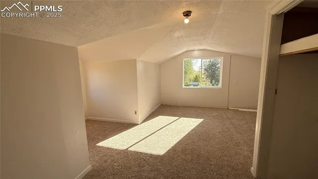 a view of a livingroom with furniture and a window
