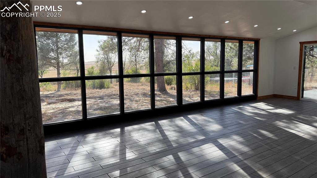 3250 Slocum Road Peyton, CO 80831 - Photo 34 of 50 a view of empty room with wooden floor and fan