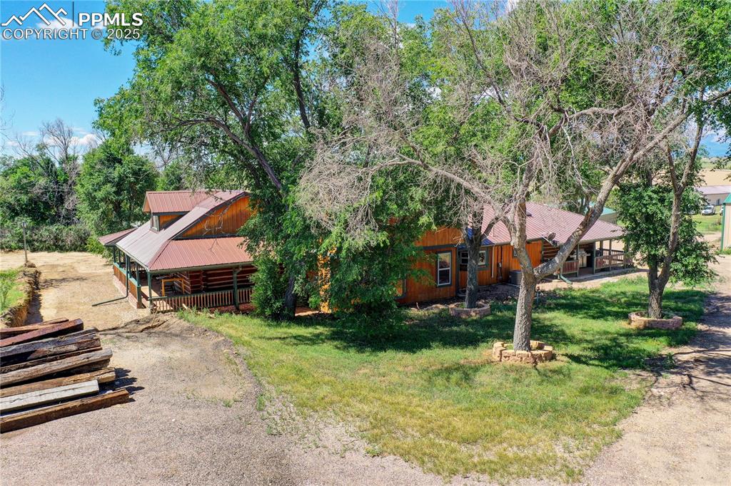 3250 Slocum Road Peyton, CO 80831 - Photo 48 of 50 a backyard of a house with yard and trampoline