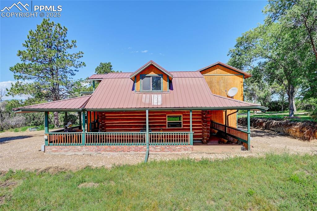 3250 Slocum Road Peyton, CO 80831 - Photo 6 of 50 a view of a house with a yard and sitting area