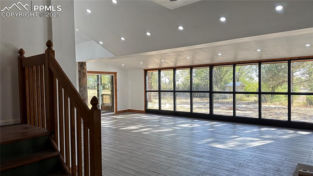 3250 Slocum Road Peyton, CO 80831 - Photo 10 of 50 a view of an empty room with wooden floor and stairs